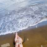 Naked woman lying on the beach elevated view Stock Photo